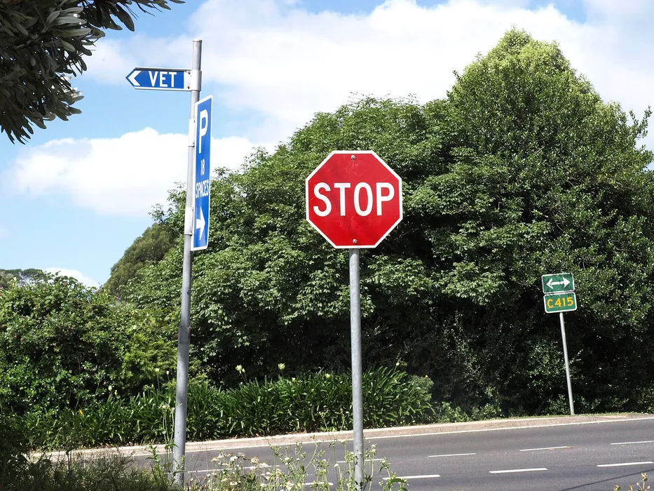 A red stop sign by a road